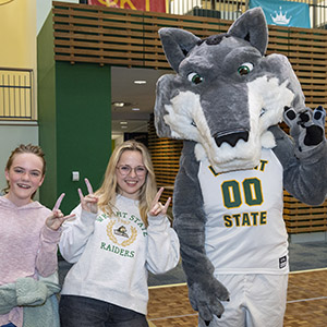 photo of a student, their sibling, and Rowdy