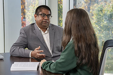 photo of a professor and student sitting and talking