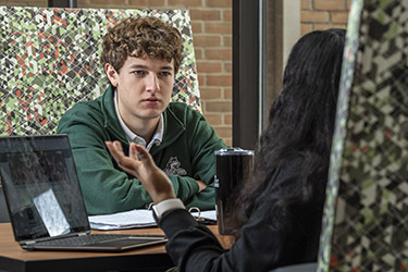 photo of students sitting at a table on campus