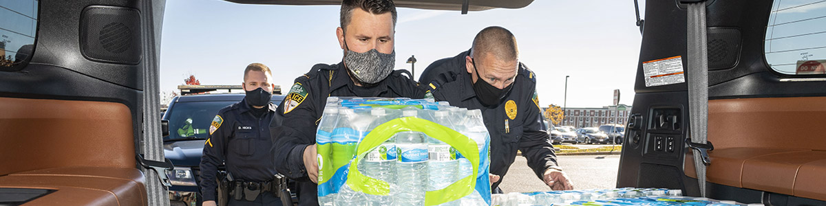 Campus police officers handing out water