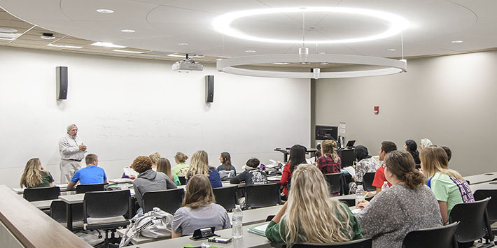 photo of students and a professor in a classroom