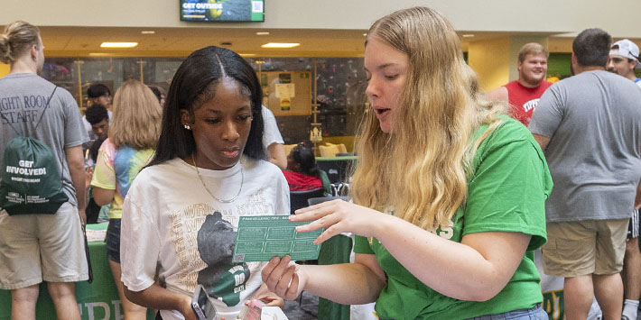 photo of two students talking at an event in the student union