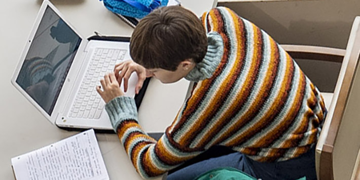 photo of a student studying in the library