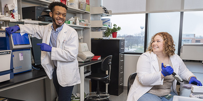 photo of two students working in a lab