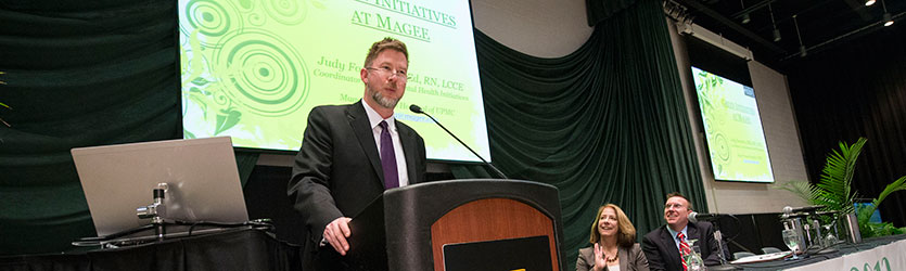 photo of someone on stage speaking at a seminar in the student union