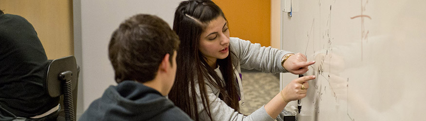 photo of a student helping another student