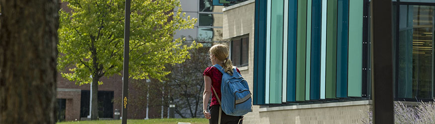 photo of a student walking on campus