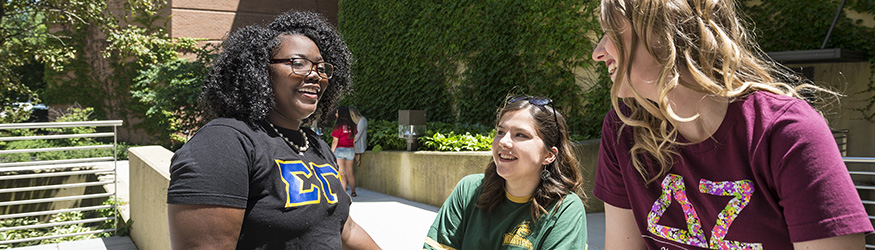 photo of three students talking and laughing