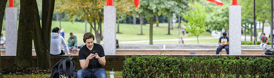 photo of students sitting outside on campus