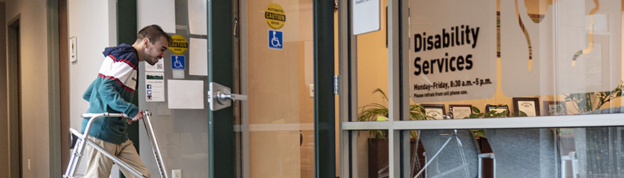 photo of a student walking into the disability services office