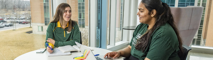 photo of students sitting at a table in the student success center