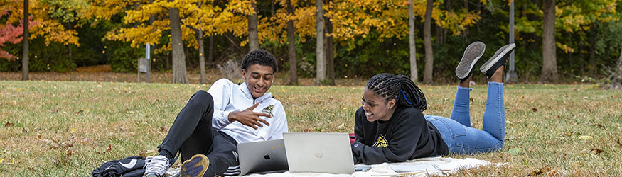 photo of students sitting outside on campus