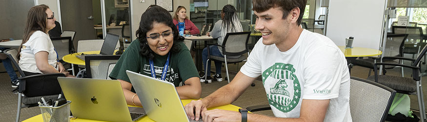 photo of students sitting at a table working together