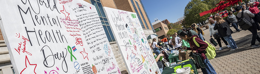 photo of people outside on campus on world mental health day