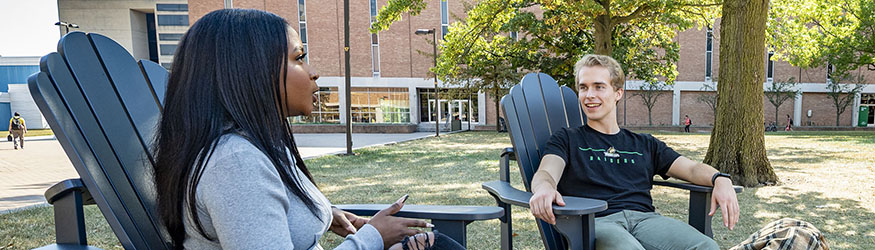 photo of students sitting outside on campus