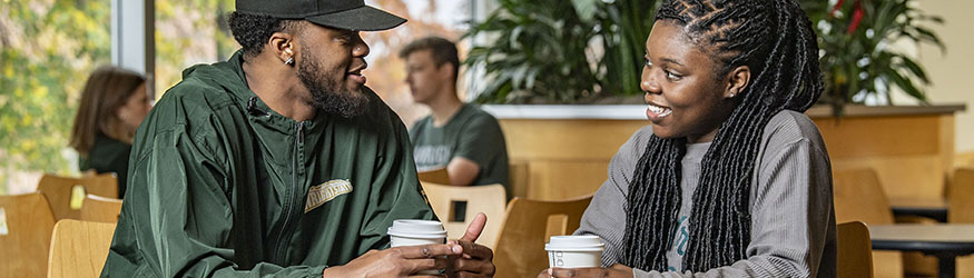 photo of students sitting at a table in the union market with drinks