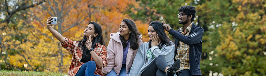photo of students taking a photo outside on campus