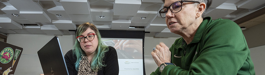 photo of two employees in a training class