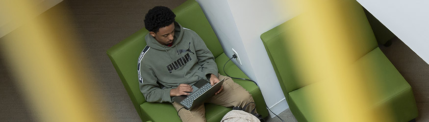 photo of a student working on a laptop