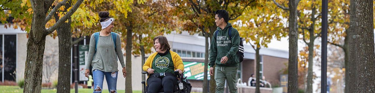 Student walking on campus in the fall