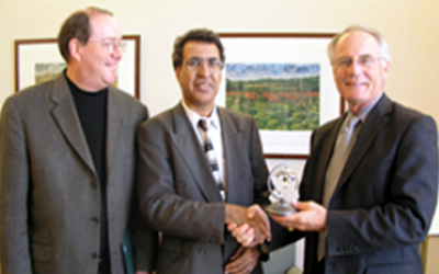 Fall Ainina, Professor and Chair of the Department of Finance and Financial Services with Provost David Hopkins, right, and Doug