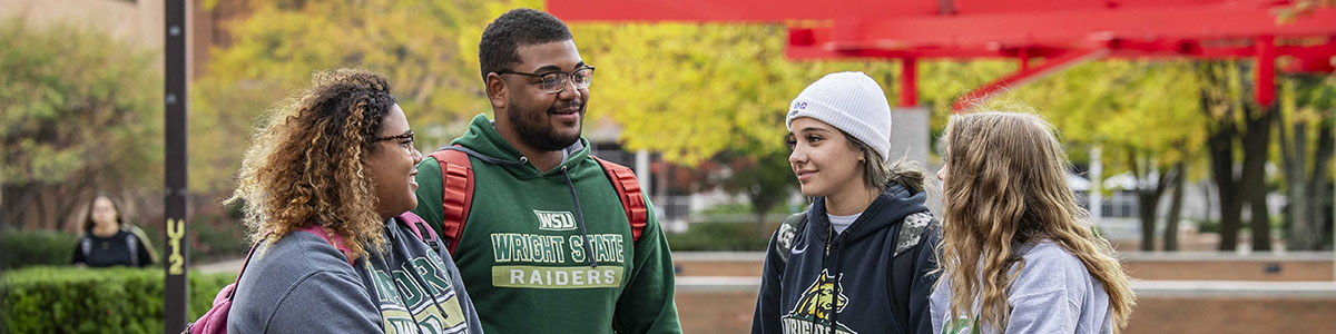 photo of students sitting outside on campus