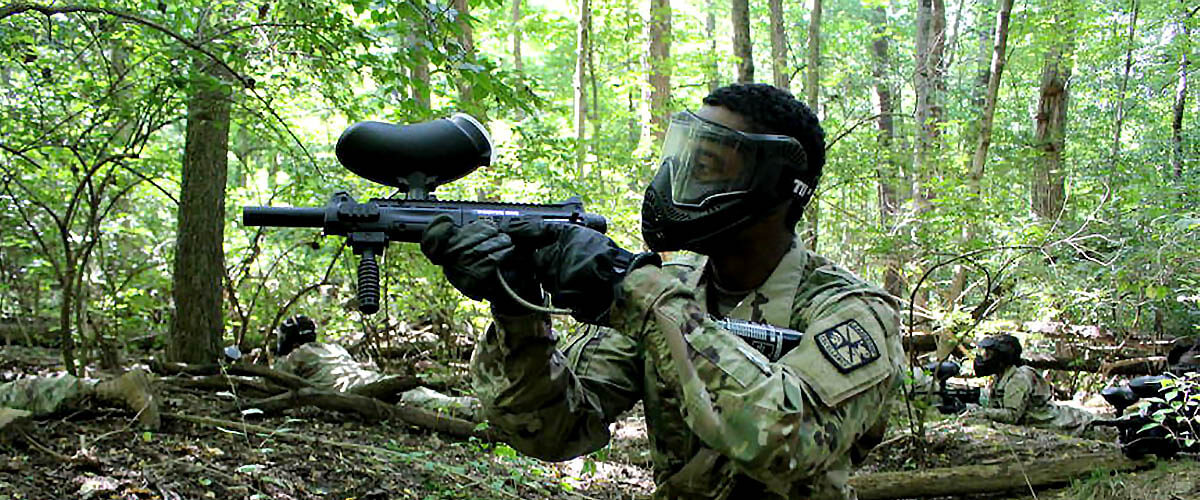 Army Rotc student competing in a paint ball match
