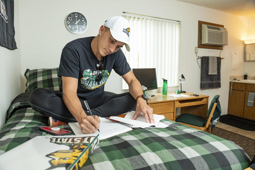 photo of a student in a dorm room