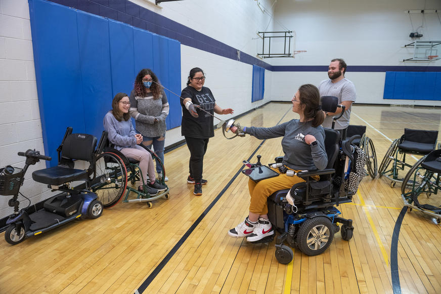 photo of students in a fencing class in the student union gym