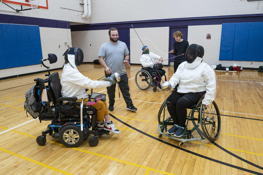 photo of students in a fencing class in the student union gym