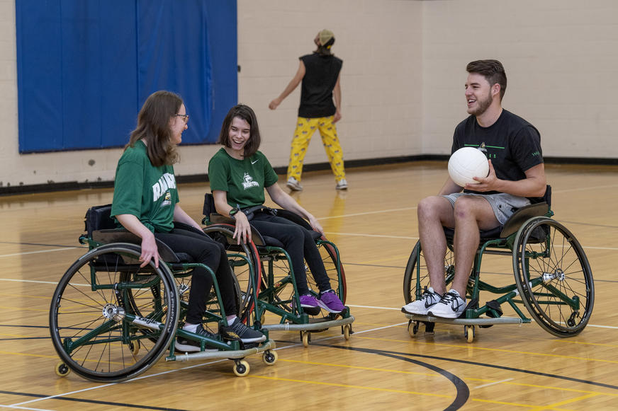 photo of students playing basketball in the student union gym