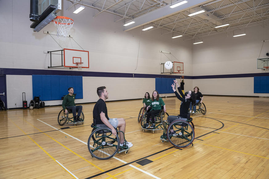 photo of students playing basketball in the student union gym