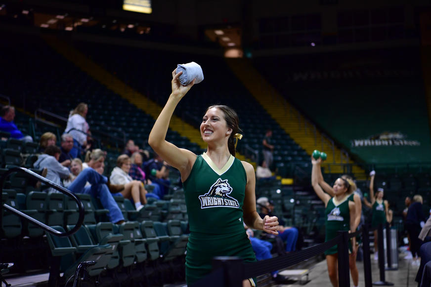 Cheerleader with t-shirt to throw to fans
