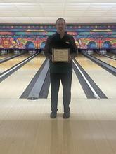 Coach Jeremy Symonds holding Coach of the Year Award